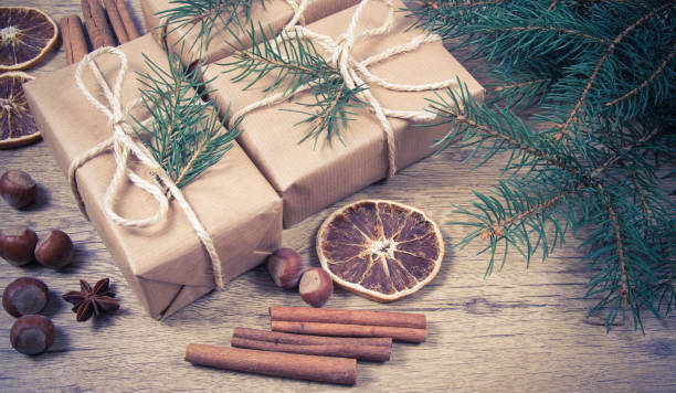 istock Christmas gifts in rustic boxes on wooden background. 880861744