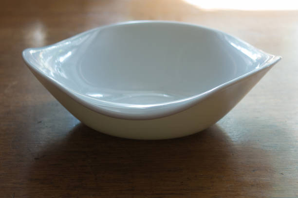 istock Bowl with wavy rim on wooden table 880862990