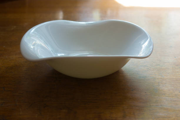 istock Dish with wavy rim on wooden table 880864338