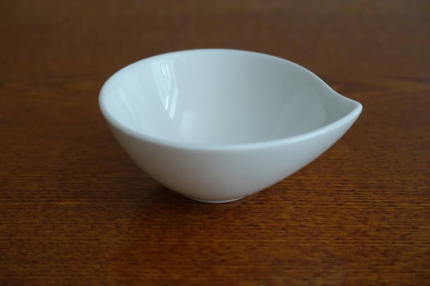 istock Small white ceramic bowl on wooden table 880866198