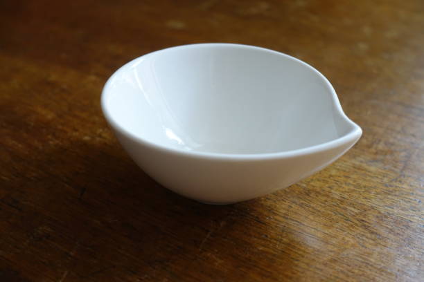 istock White porcelain bowl with spout on wooden table 880866422