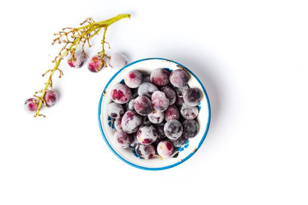 Frozen grapes cluster on white background Frozen grapes cluster with ice on white background frozen grapes stock pictures, royalty-free photos & images