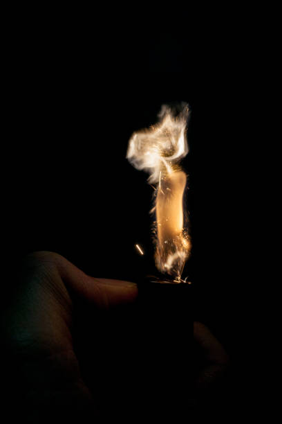 istock Close up view of real sparking light from lighter in dark black background 880891144