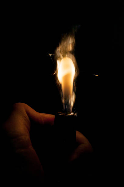 istock Close up view of real sparking light from lighter in dark black background 880891200