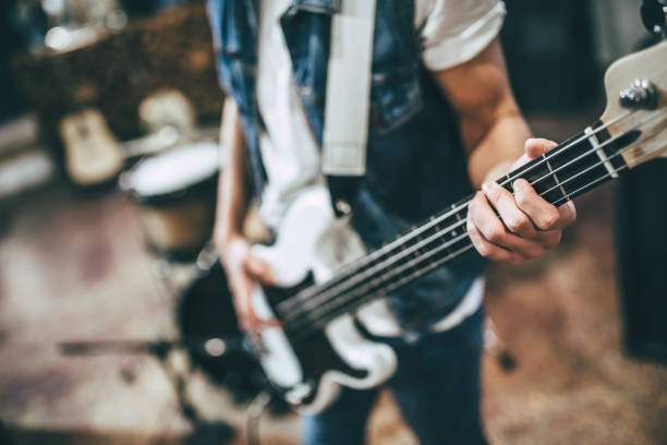 Music band repetition Repetition of rock music band. Cropped image of bass guitar player. Rehearsal base bass guitar photos stock pictures, royalty-free photos & images