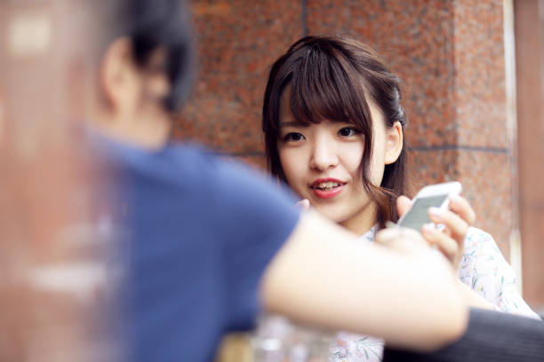 istock Passing the phone over to show a social media post on the application 880908368