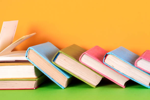 istock Open book, hardback books on bright colorful background. 880908882