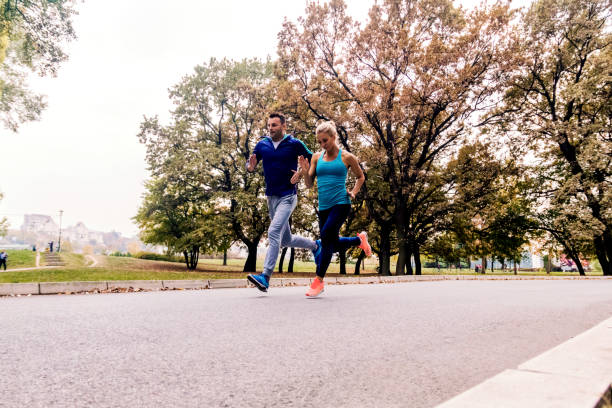 istock Jogging couple - young man and woman competing 880911164