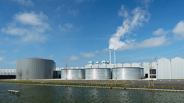 istock greenhouse with storage tanks and canal infront 880914482