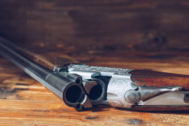istock Open hunting rifle isolated on wooden background 880914952