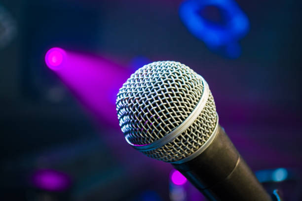 istock microphone against blur colorful light in music studio 880921004