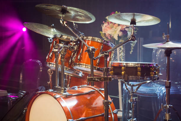 istock drum set on stage and magenta light background 880921058