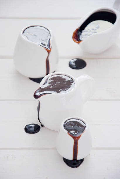 istock Dark chocolate sauce in white sauceboats 880923904