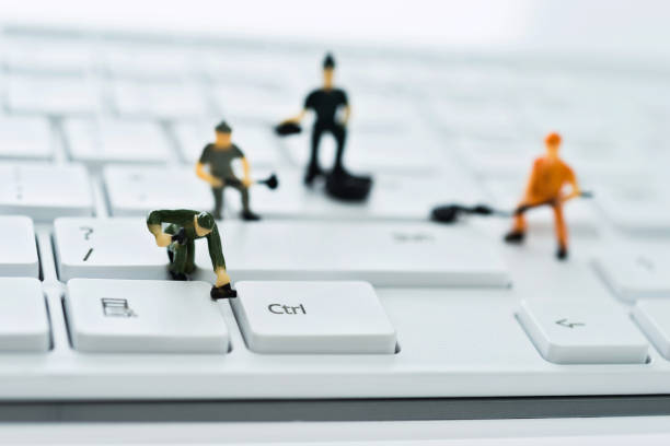 A group of figurines cleaning computer keyboard A group of figurines cleaning computer keyboard human representation photos stock pictures, royalty-free photos & images