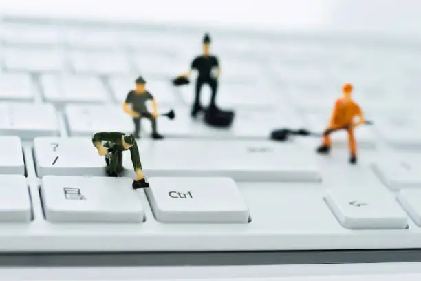 Photo of A group of figurines cleaning computer keyboard