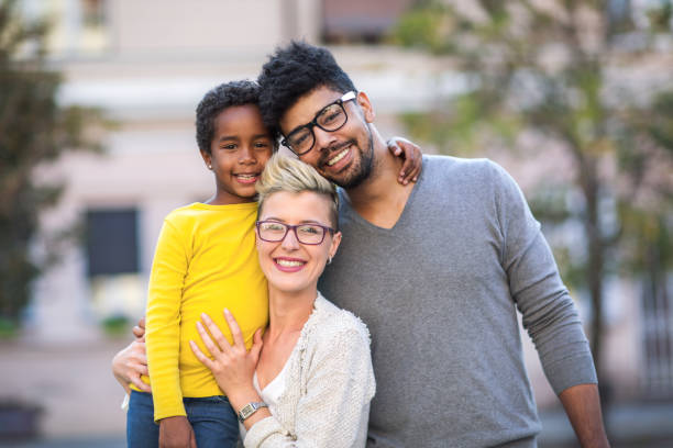 istock Happy young mixed race couple spending time with their daughter 880927404
