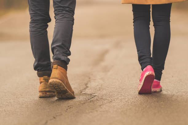 Young couple / pair walking down the street.