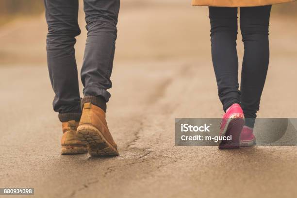 Young Couple Pair Walking Down The Street Stock Photo - Download Image Now - Foot, Two People, Walking