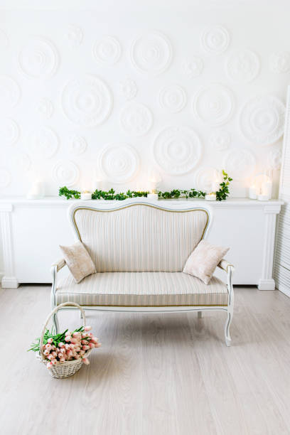 istock Modern living room in bright colors. A warm white room with a light sofa and a bright. 880937006