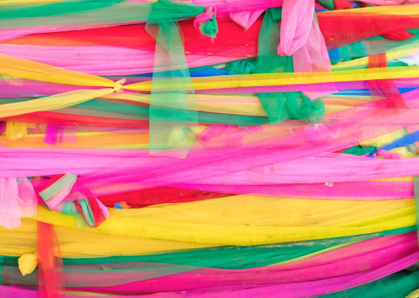 istock Colorful Thai style fabric which tied around the large tree. 880956424
