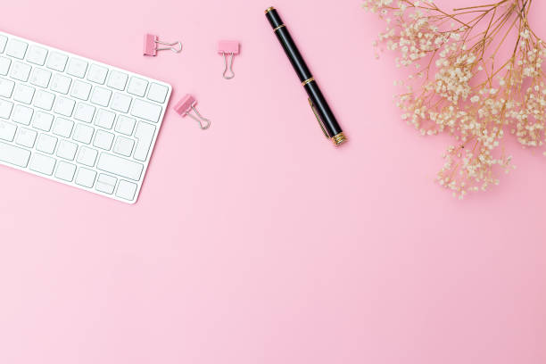 istock Keyboard and stationery on a pink background. Copy space 880957088