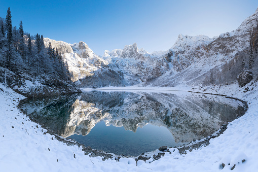 View of the frozen lake of Limides with the reflection of the snowy peak of Lagazuoi in the ice cracks, Dolomites, Passo Falzarego, Veneto, Belluno province, Italy, Europe