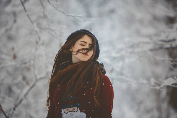 istock Portrait Young beautiful woman throws snow 880972808