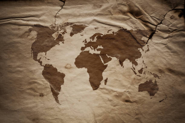 istock World Map on aged damaged paper 880972904