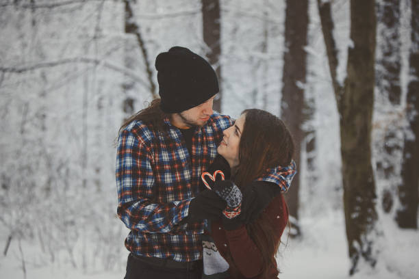 istock Loving couple in snowy winter forest 880976306