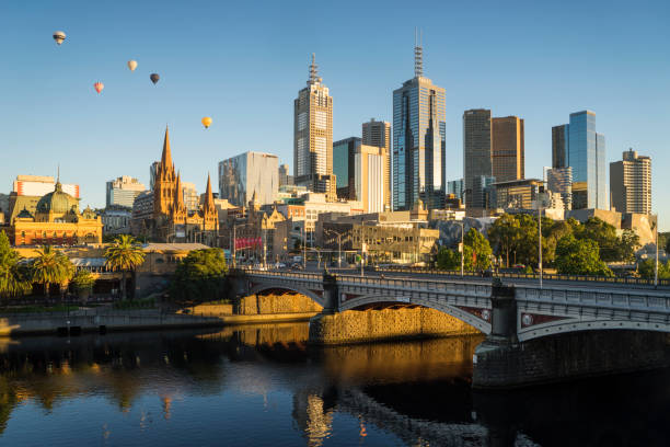 Hot air balloons above Melbourne Hot air balloons floating above the Melbourne skyline at dawn. yarra river stock pictures, royalty-free photos & images