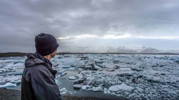 istock Asian senior man with Iceland glacier amazing view 880976678