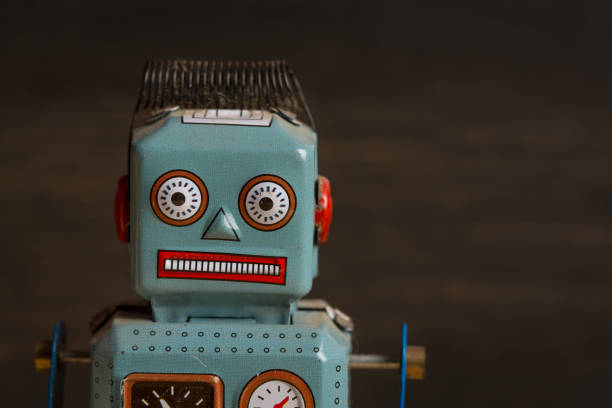 istock Tin toy robot against dark wood background 880984730