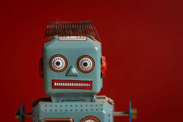 istock Tin toy robot against red background 880984780