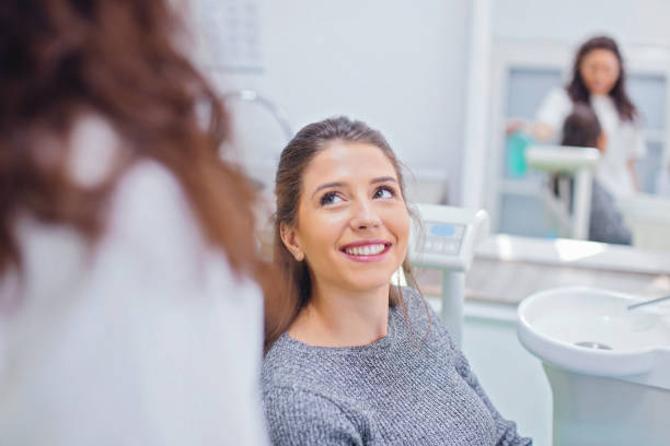 istock Young woman at dentist office 880985452