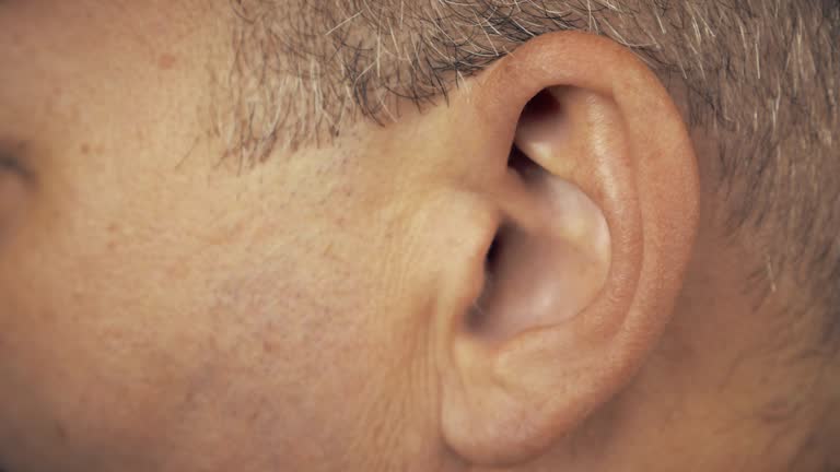 Man left ear. Macro extreme close up view of male ear. Concept for audio music sound health human ear.