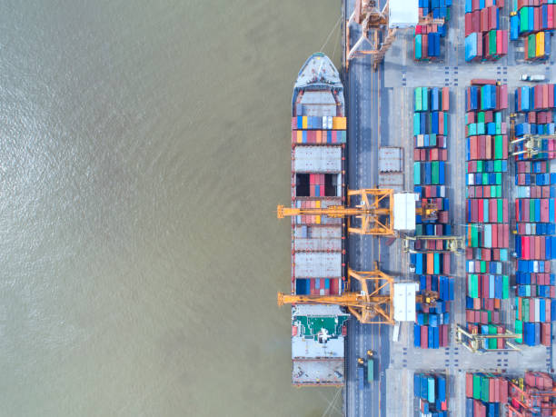 istock container,container ship in import export and business logistic,By crane,Trade Port , Shipping,cargo to harbor.Aerial view,Water transport,International,Shell Marine,transportation,logistic,trade,port 880995898