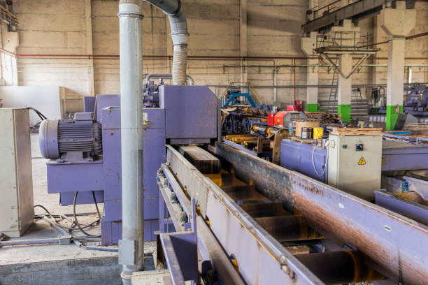 istock Sawmill. The process of cutting logs into boards. Automatic line sawing 880997526