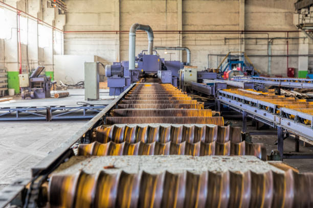 istock Sawmill. The process of cutting logs into boards. Automatic line sawing 880997544