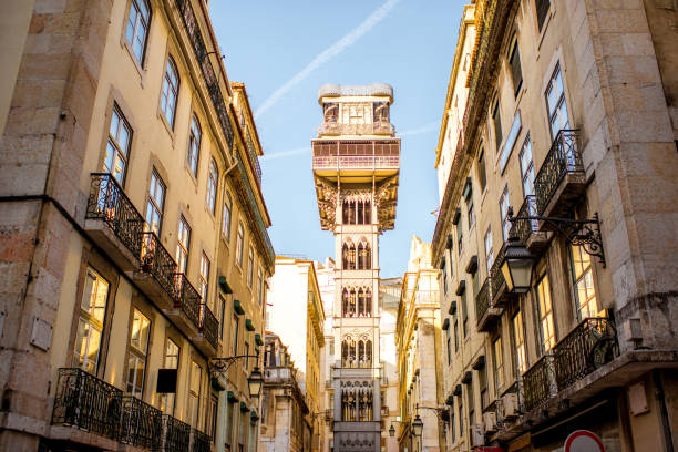 Lisbon city in Portugal Street view on the old buildings with famous saint Justa metal lift during the sunrise in Lisbon city, Portugal santa justa lift portugal stock pictures, royalty-free photos & images