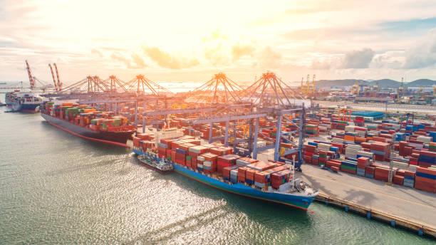 istock container,container ship in import export and business logistic,By crane,Trade Port , Shipping,cargo to harbor.Aerial view,Water transport,International,Shell Marine,transportation,logistic,trade,port 881015168