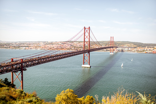 Landscape view on the Tagus river and the famous 25th of April Bridge in Lisbon city, Portugal