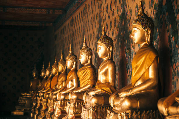 istock Row of Buddhas in a temple 881031126