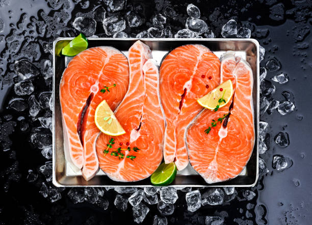 istock Salmon steaks on ice on black background 881041212