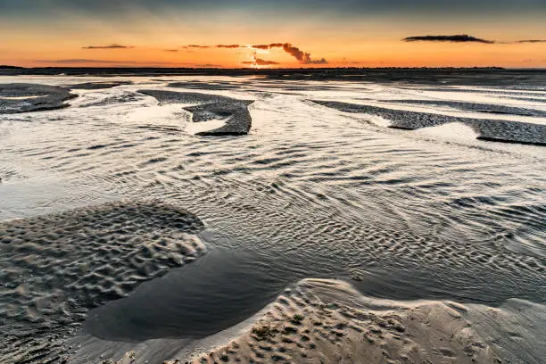 Photo of Sunrise on the sea at the Baie de Somme at low tide