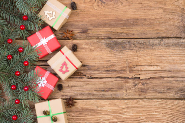 istock Christmas presents on wooden background 881049192