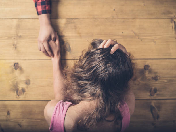 istock Man comforting sad and upset woman at table 881057796