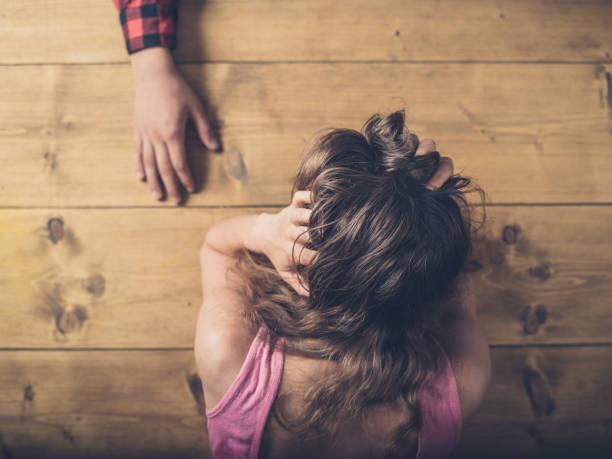 Man comforting sad and upset woman at table
