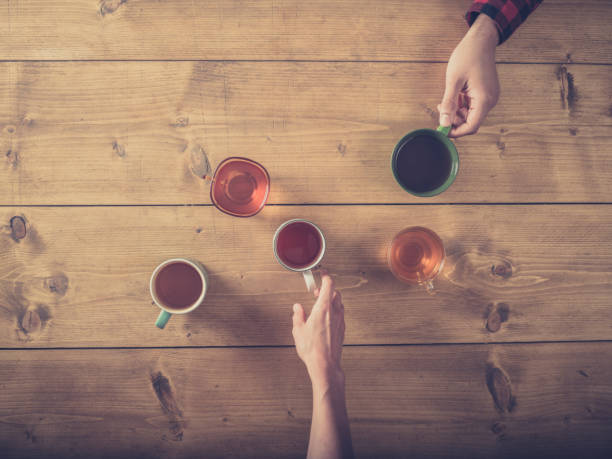 Man and woman drinking cups of tea