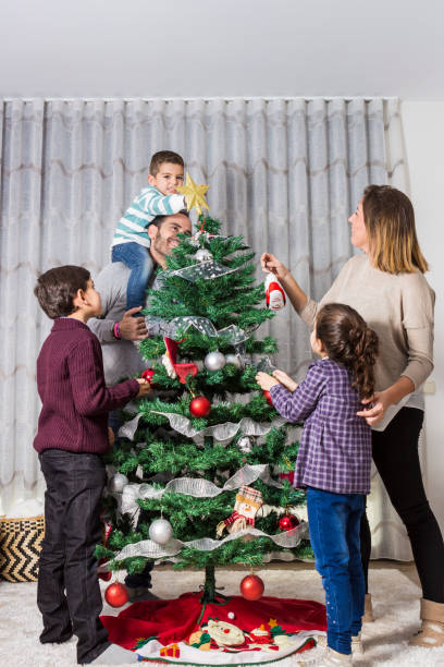 istock Family decorating Christmas tree 881061154