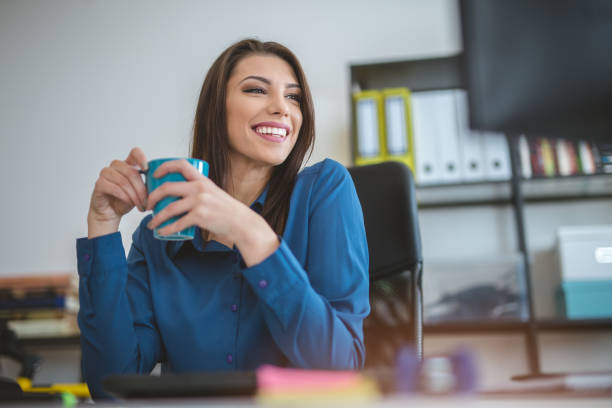 istock Businesswoman having coffee at her desk 881061740